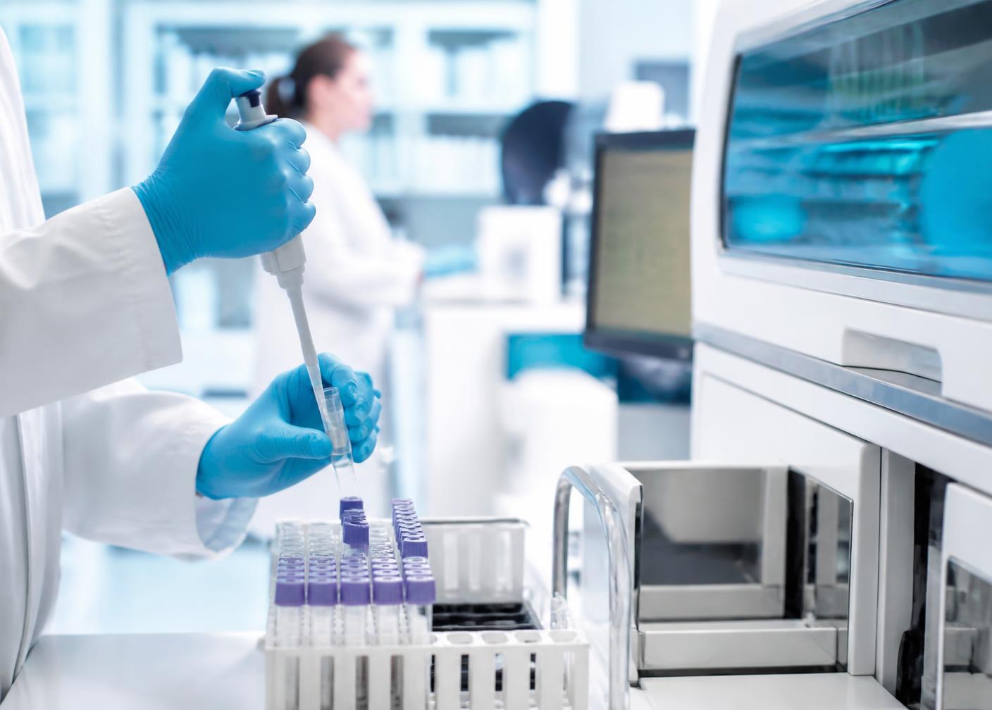 Laboratory technician processing patient samples in the Al-Madina diagnostic laboratory